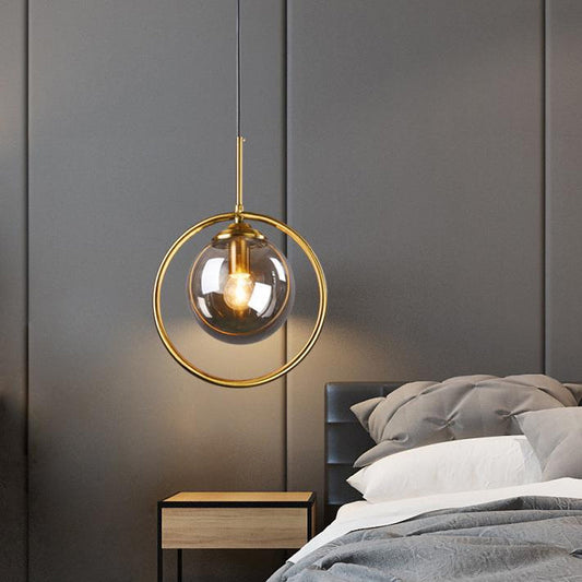 Postmodern Glass Pendant Light with Brass Ring for Bedroom - Single-Bulb Globe Down Lighting in Clear, Amber, and Smoke Grey
