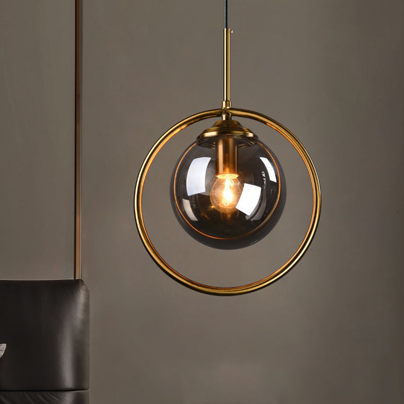 Postmodern Glass Pendant Light with Brass Ring for Bedroom - Single-Bulb Globe Down Lighting in Clear, Amber, and Smoke Grey