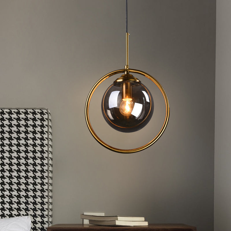 Postmodern Glass Pendant Light with Brass Ring for Bedroom - Single-Bulb Globe Down Lighting in Clear, Amber, and Smoke Grey