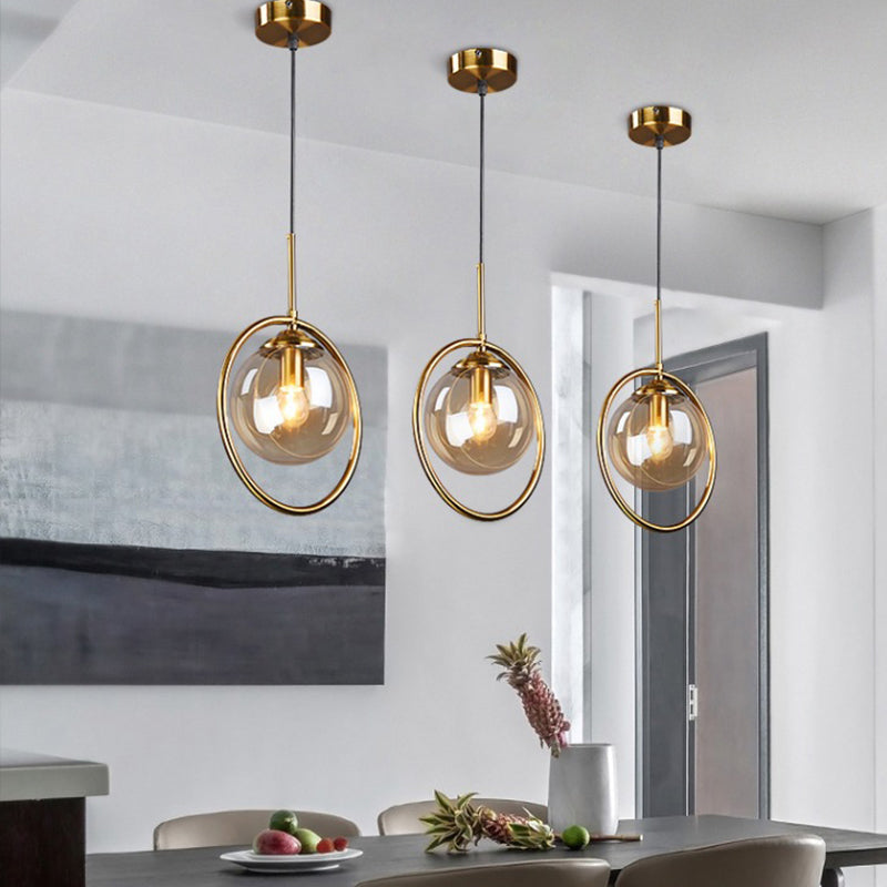 Postmodern Glass Pendant Light with Brass Ring for Bedroom - Single-Bulb Globe Down Lighting in Clear, Amber, and Smoke Grey