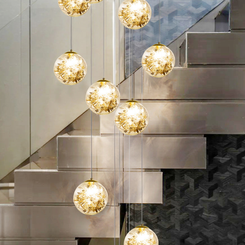 Lustre sphérique moderne avec accents floraux en verre transparent et métal doré - 10 lumières pour escaliers