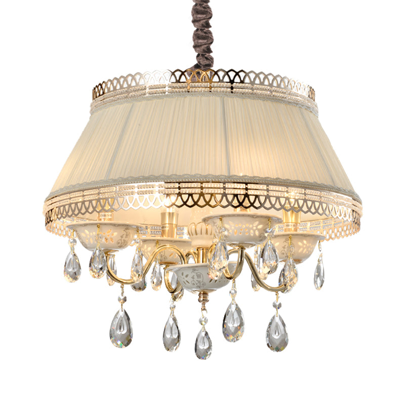 Lustre suspendu contemporain à 4 ampoules avec abat-jour tambour en tissu beige et éclairage vers le bas en cristal